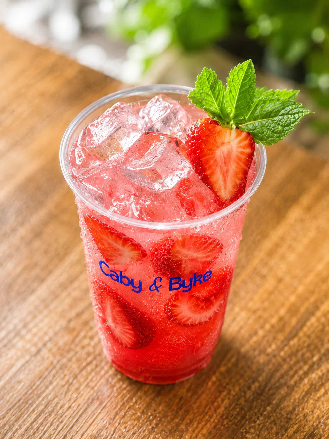 Top view of Floral Strawberry Chiller with fresh strawberries, mint, and ice cubes.