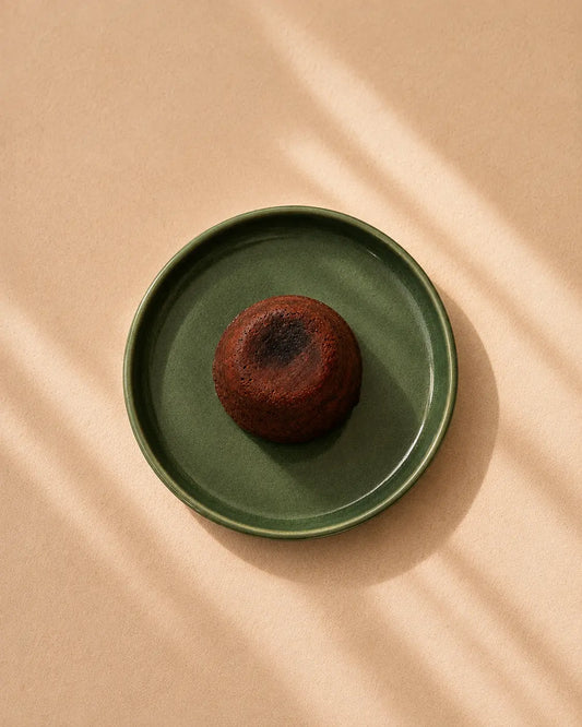 Top view of a chocolate lava cake served on a green plate
